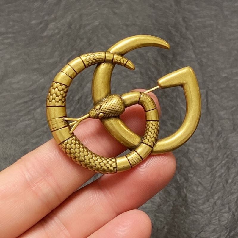G*u*i brooches